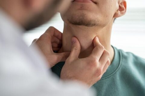 An ENT doctor examining a man's neck in Fort Worth, TX