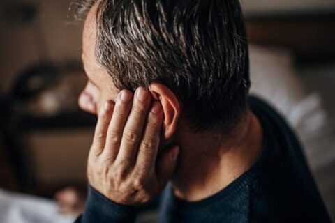 A man experiencing discomfort from an ear infection in Fort Worth, TX