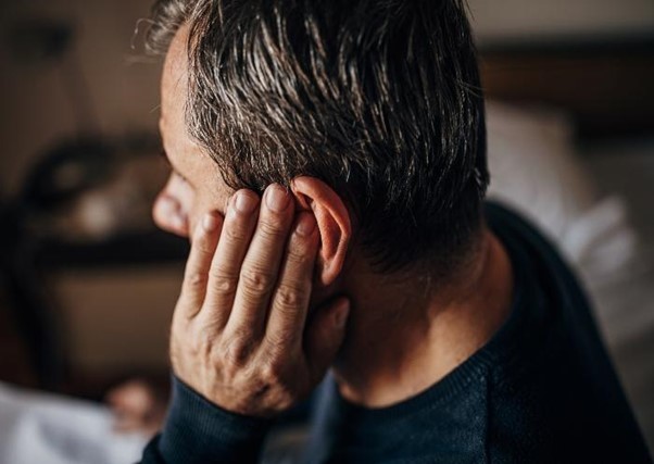A Man Places his Hand to his Ear Highlighting in Need of Ear Treatment in Fort Worth, TX